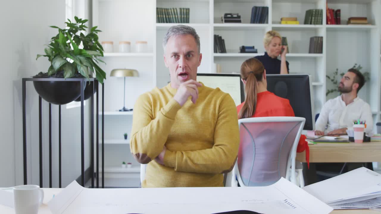 Business man talking about a project to the camera