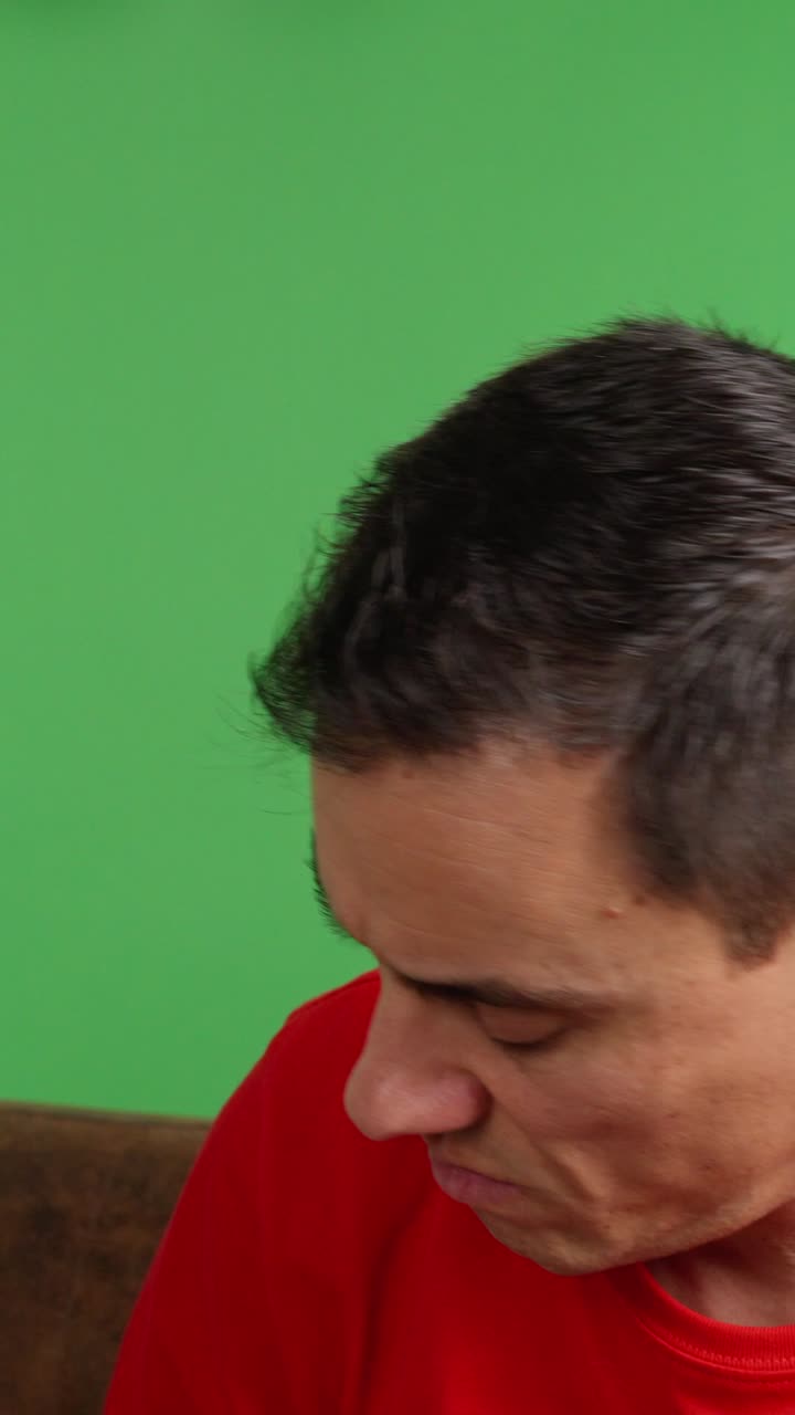 Sad man waiting for a message on green screen background