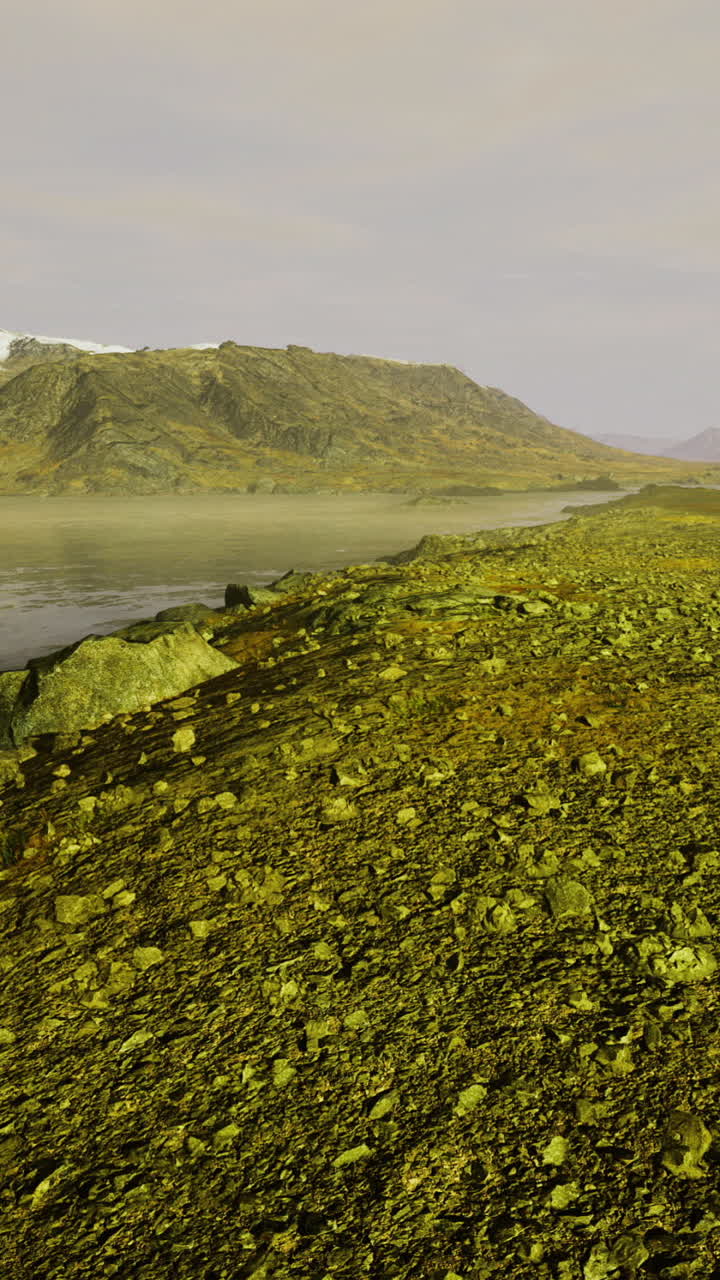 Majestic landscape with smooth waters reflecting mountains under a gentle sky