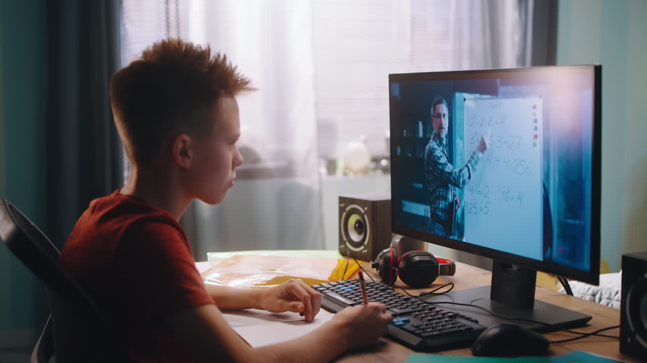 Teenage boy studying book in library
