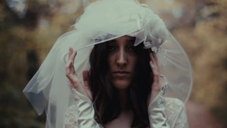 melancholic bride in wedding veil outdoors