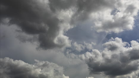 a long 4k time lapse of fast moving and dramatic afternoon cumulus clouds moving from right to left across a tropical sky