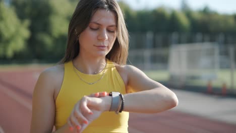 woman jogging on outdoor track in sportswear at athletic field