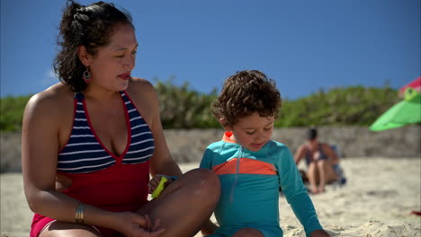 Cámara-Lenta-De-Una-Madre-Latina-Mexicana-En-Traje-De-Baño-Jugando-Con-Su-Hijo-En-La-Playa-De-Cancún