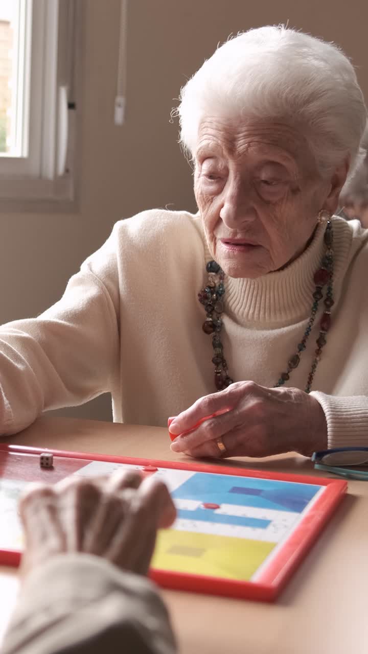 Senior people playing board game in retirement home