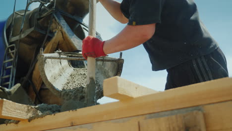 pour concrete from the mixer into the formwork in the background blurred new buildings construction