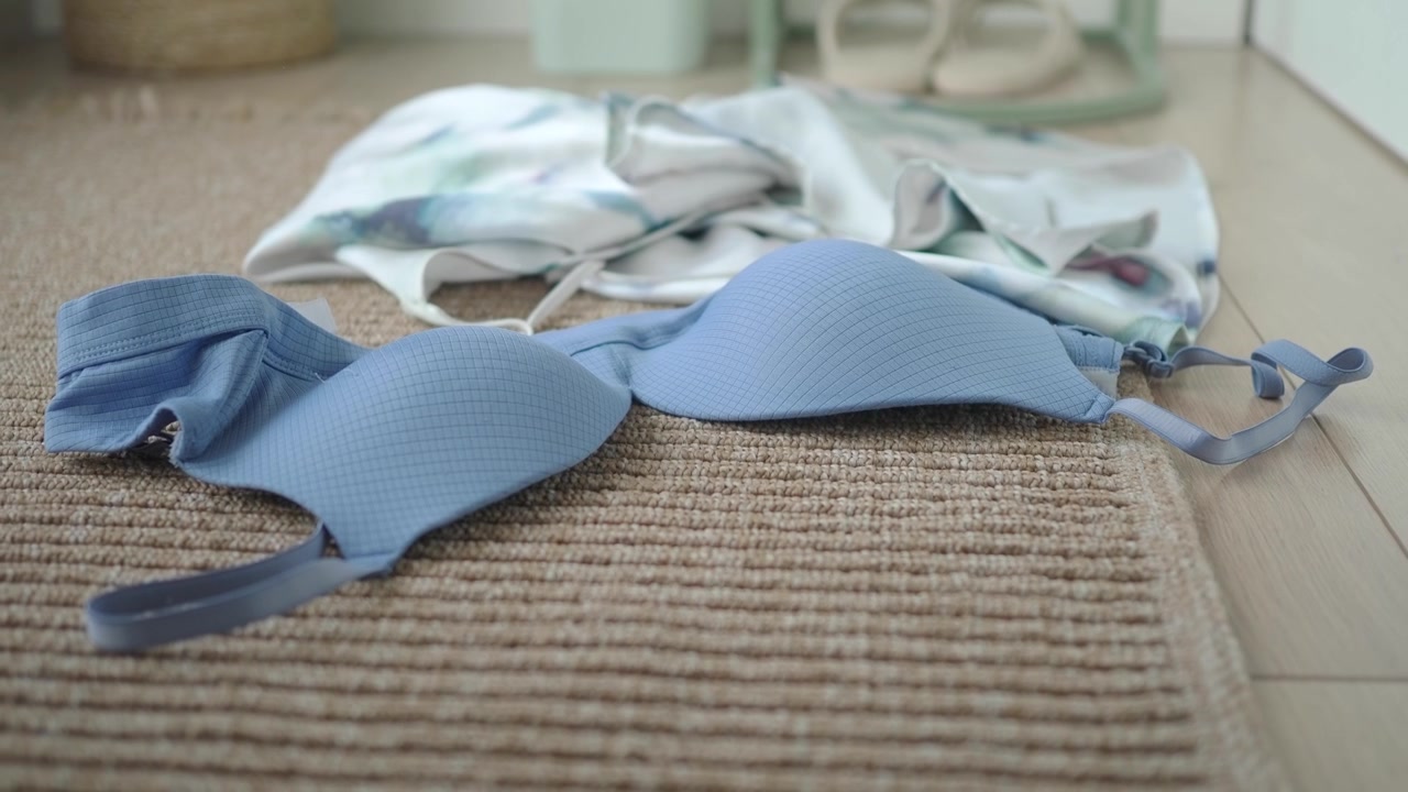 Blue Bra and Clothing Lying on Bedroom Floor
