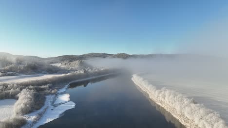 Aerial-shot-of-a-misty-layered-Norwegian-landscape-with-a-train-track-bridge