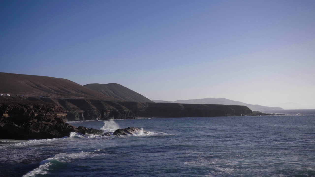 Wide angle view of the coast of Fuerteventura, Canary Islands, wide waves rolling in