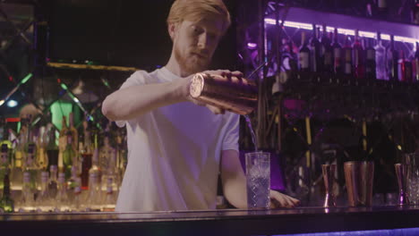 bartender preparing drink using a cocktail shaker 1