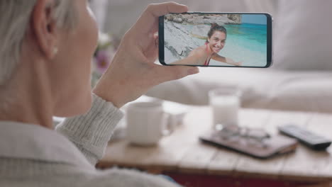 mature woman having video chat using smartphone waving at daughter on vacation beach in italy sharing travel experience on mobile phone enjoying connection chatting to grandmother 4k