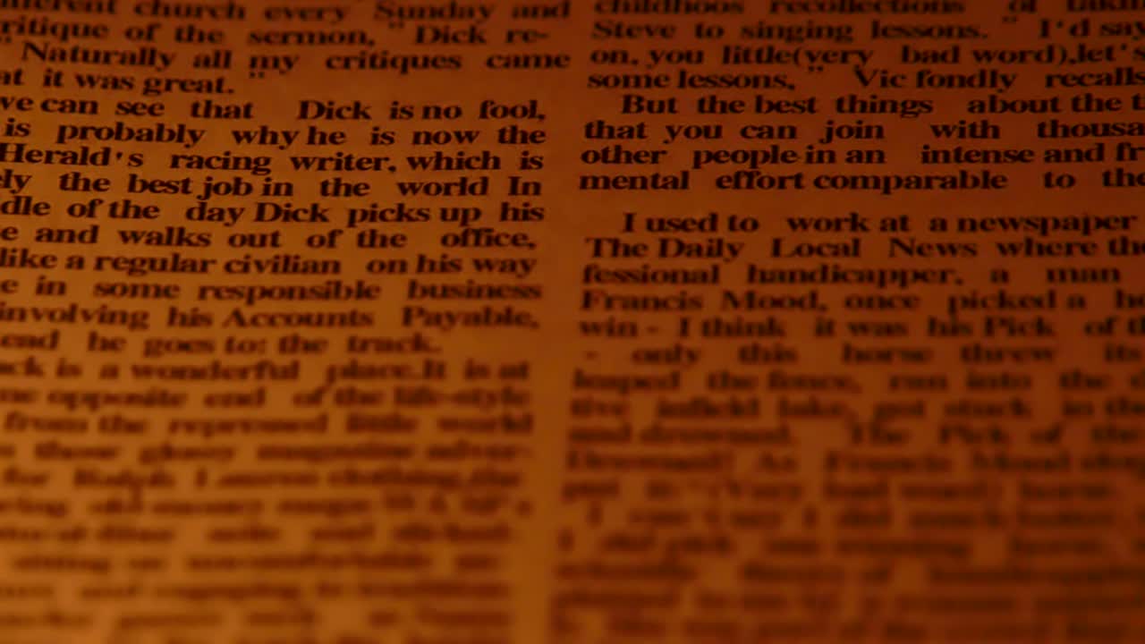 The prints on the newspaper on a yellow light