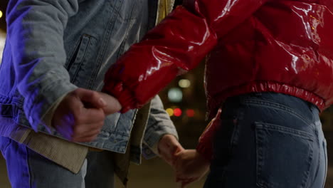 Unknown-couple-dancing-on-urban-background.-Man-and-woman-holding-hands.