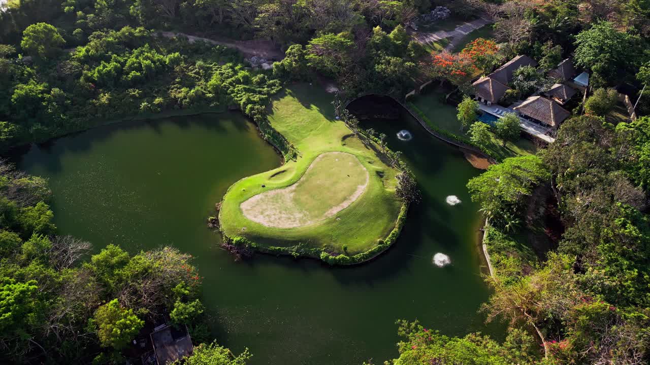 This cinematic drone video shows the green heart of Nusa Dua’s golf course in Bali, surrounded by water and forest, highlighting the harmony between sport, leisure, and tropical nature