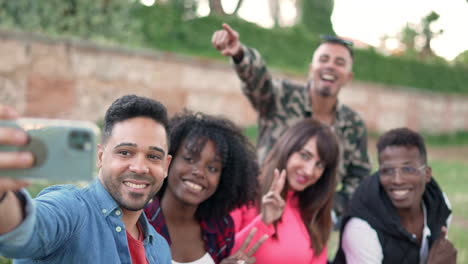 diverse group of happy friends taking a selfie outdoors