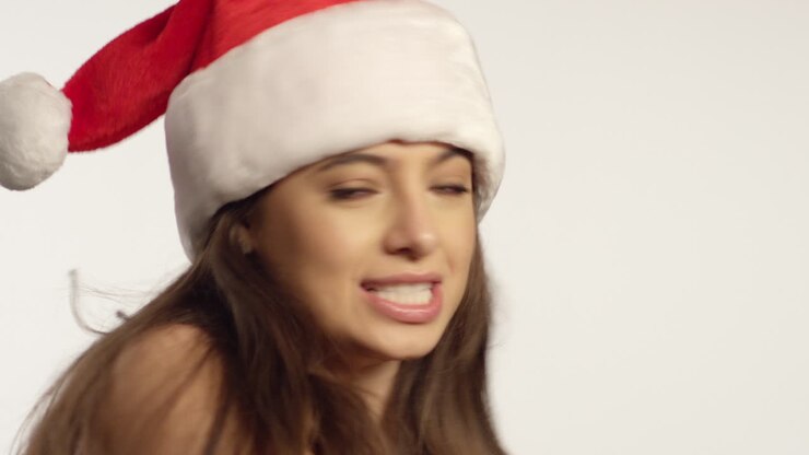 CU Woman Wearing Santa Hat Sings To Camera