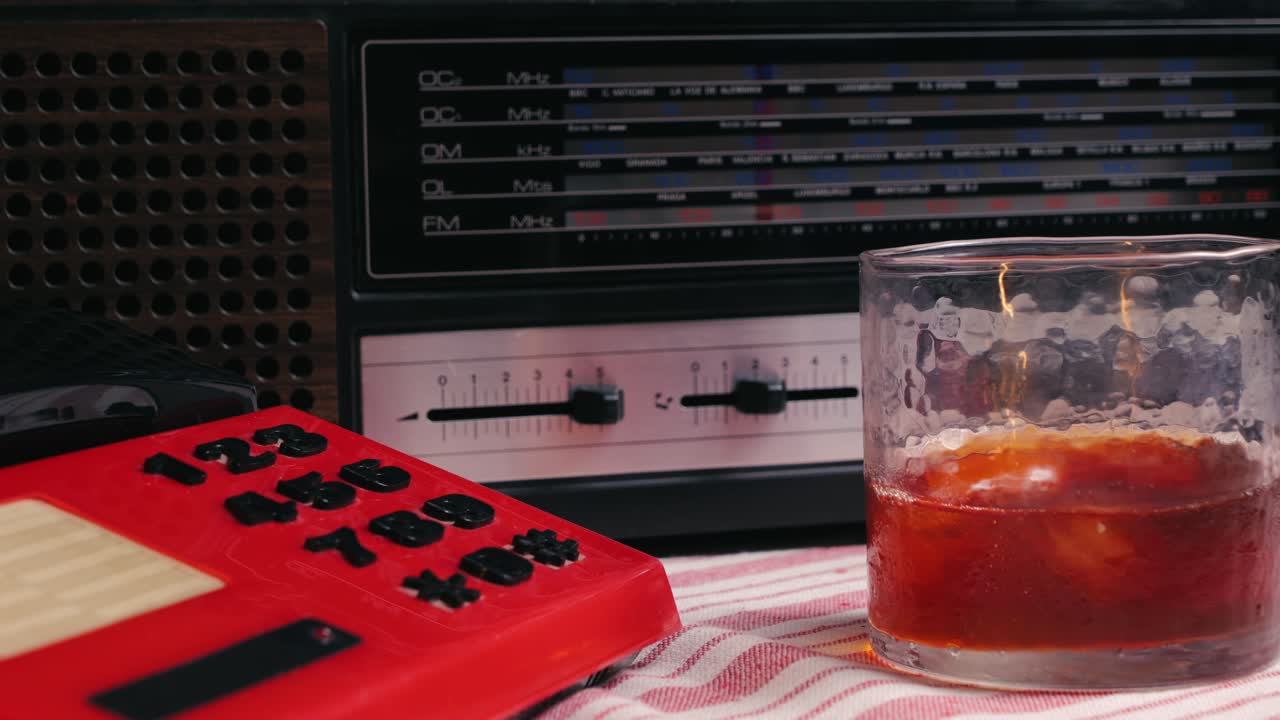 Retro vintage red phone, telephone is displayed on a wooden desk, adding a nostalgic touch. Man answer for call on button 90 phone.