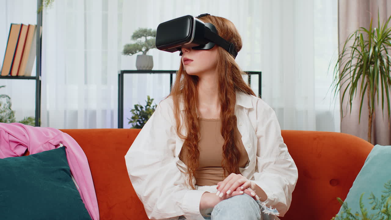 Teen girl use virtual reality futuristic technology headset to play simulation 3d video game at home