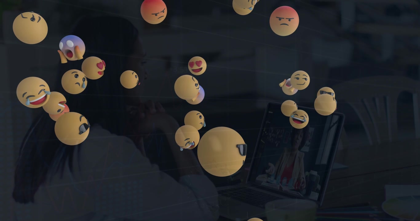 Animace padajících emotikonů nad ženami používajícími notebook.