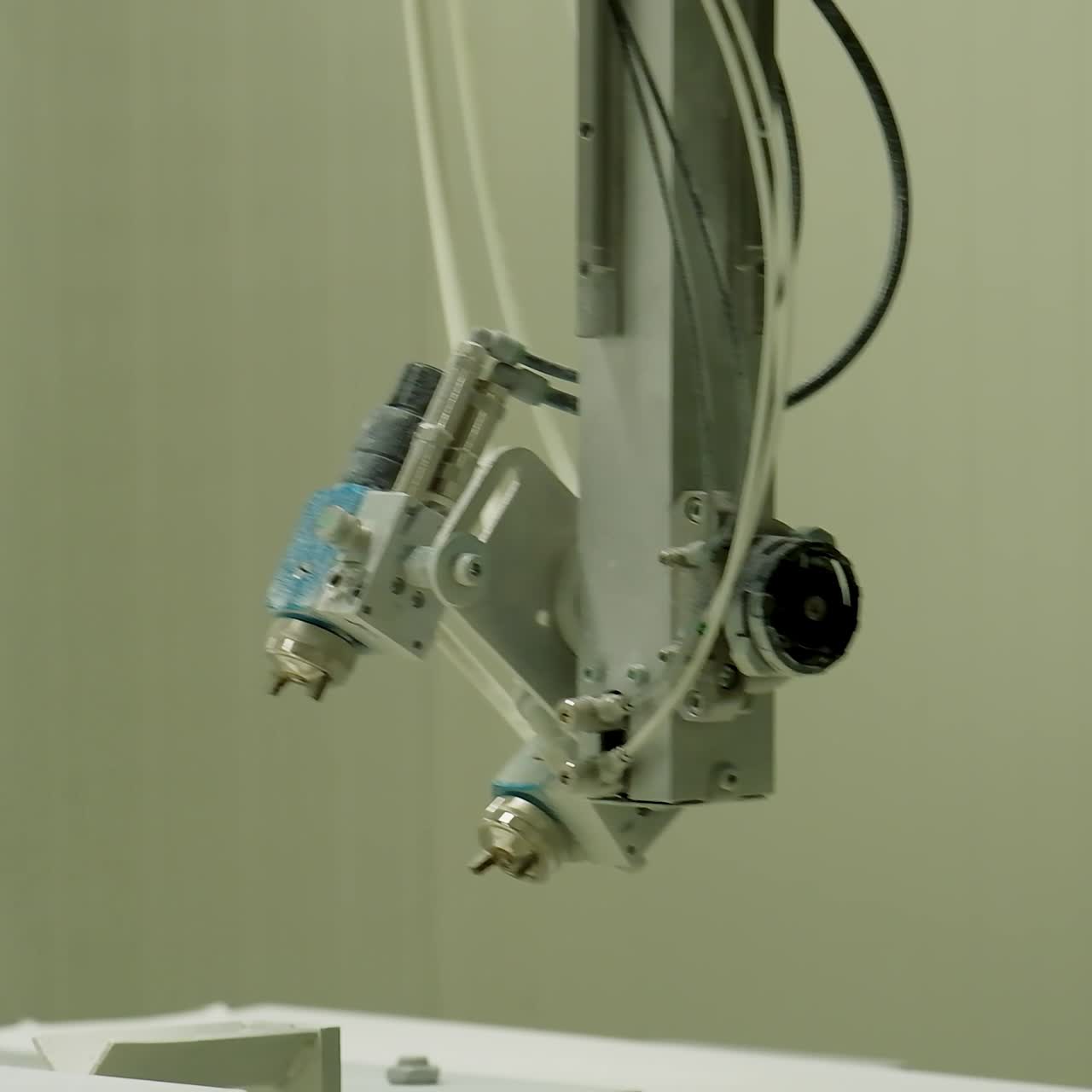 Industrial sprayer in the workshop. Automated machine tool inside the door production manufacturing. Close-up.