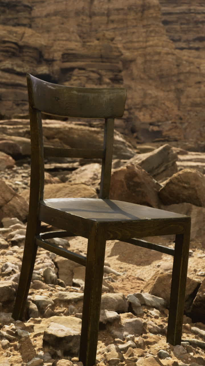 Lonely chair on rocky terrain in a remote desert landscape during midday