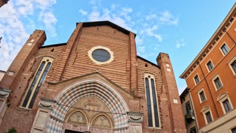 ground-level shot showing gothic façade of santa anastasia basilica, verona.