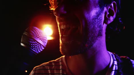 male singer singing into a microphone 4k