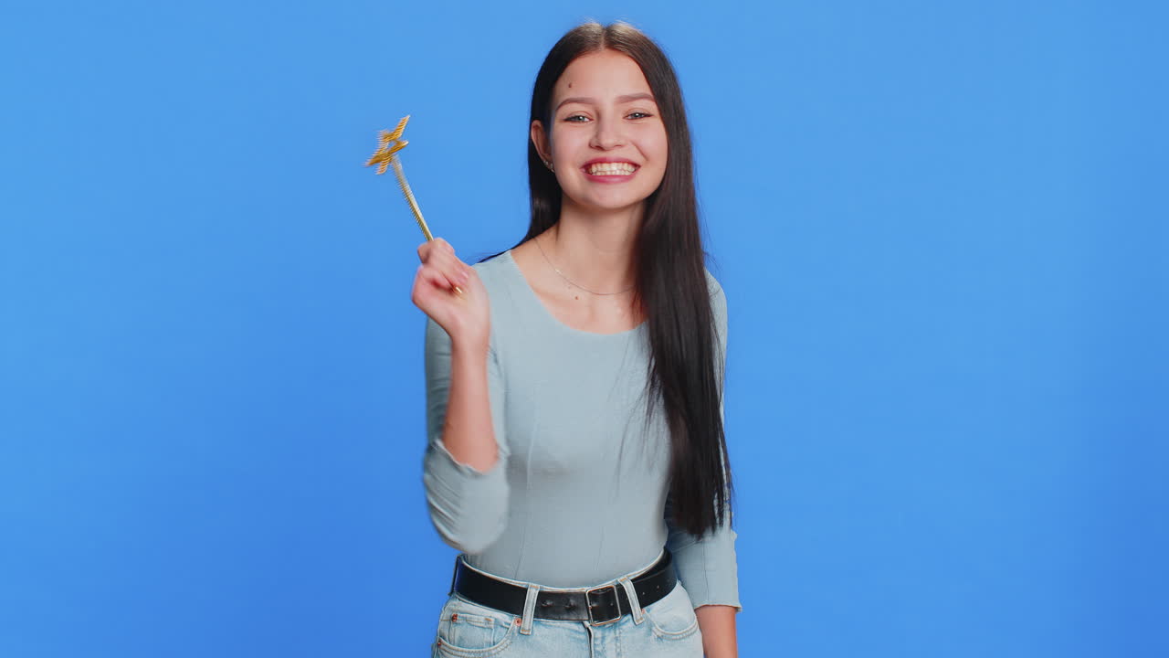 Magician witch young woman gesturing with magic wand making wish come true casting magician spell