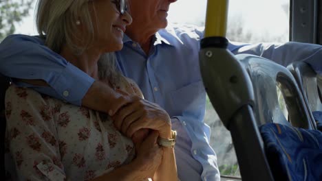 Senior-couple-interacting-with-each-other-while-travelling-in-bus-4k