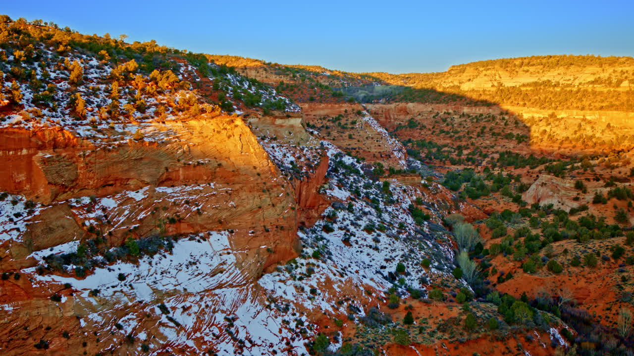 Aerial footage gliding over the dramatic, red-hued canyonlands near Page, Arizona.