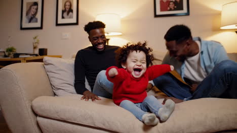 family laughing together on the couch