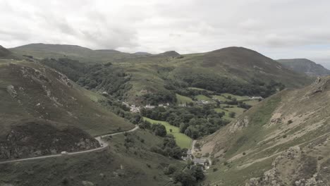 Capelulo-Penmaenmawr-Welsh-mountain-coastal-valley-aerial-view-north-wales-low-left-orbit