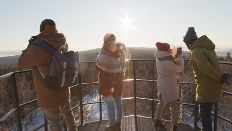 friends enjoying a winter mountaintop view