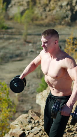 sporty man with dumbbells. muscular man exercising with dumbbells