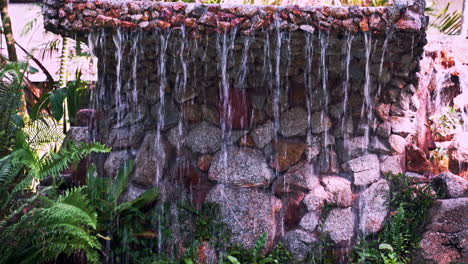 Riachuelos-De-Agua-Que-Caen-Al-Estanque-Del-Jardín-Desde-La-Losa-De-Piedra-Tallada-Arriba