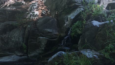 4k-UHD-handheld-footage-of-a-small-waterfall-in-a-stream-or-river-just-off-a-hiking-trail-in-the-mountains-of-rural-California,-USA