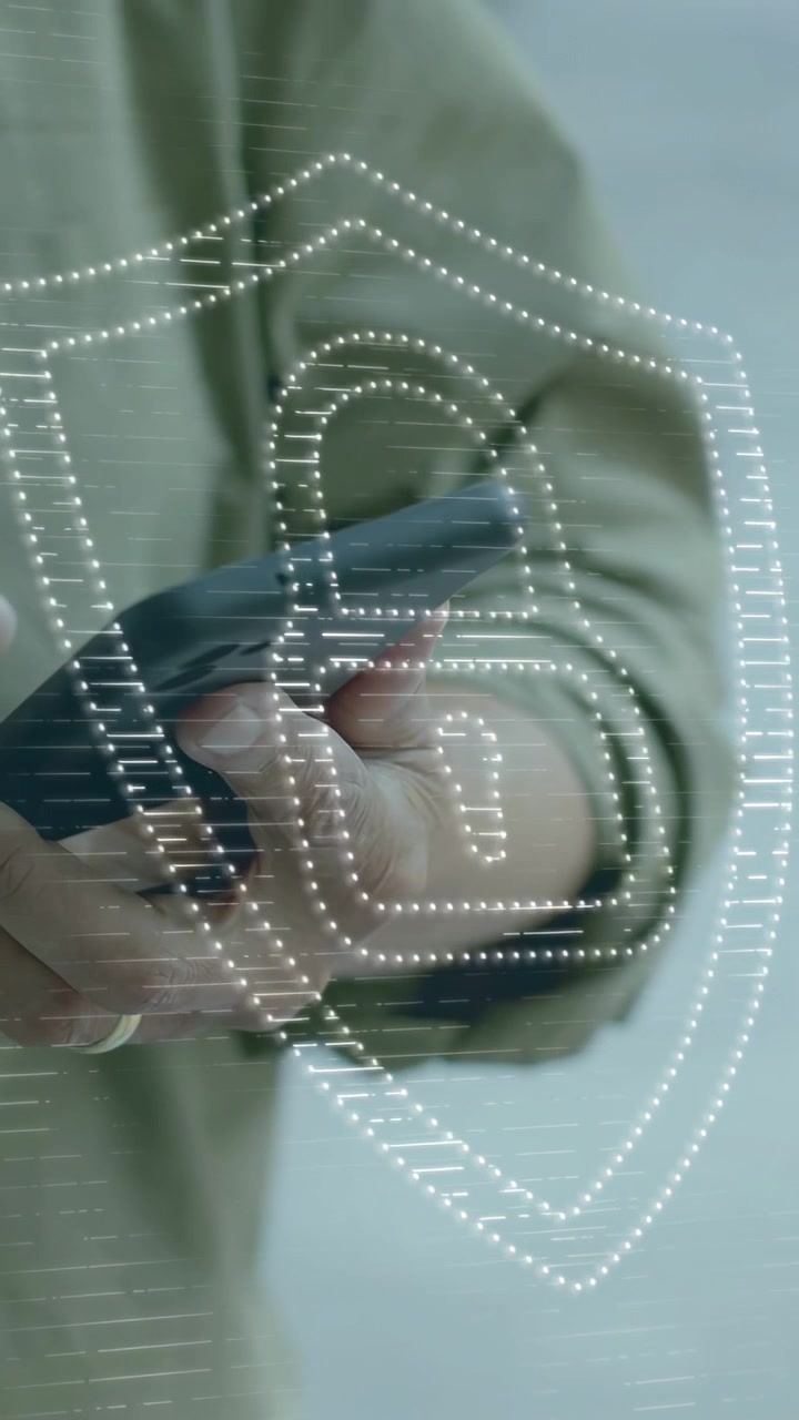 Vertical video: Mature man tapping phone and activating dotted shield padlock forming for security