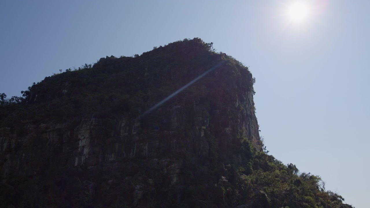 Limestone Karst Mountain Against A Sunny Sky In Ha Long Bay, Vietnam. Low-Angle Shot