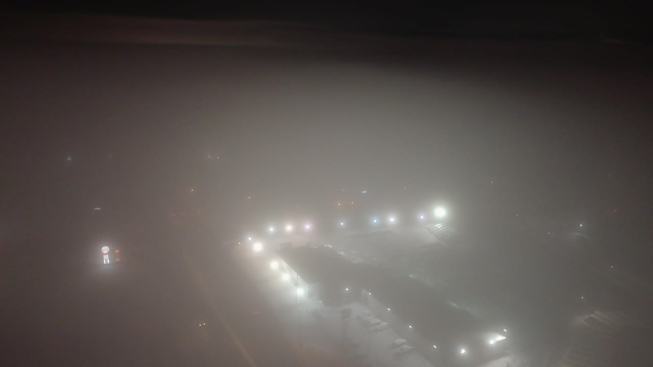 Foggy aerial night view of St-Constant, Quebec, with streetlights glowing softly