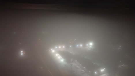 foggy aerial night view of st-constant, quebec, with streetlights glowing softly