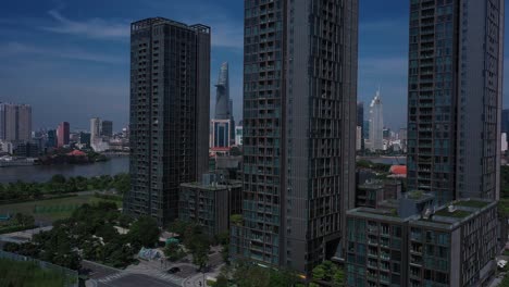 Aerial-Vietnam,-Ho-Chi-Minh-City-iconic-buildings-of-Skyline-on-sunny-clear-day-featuring-architecture,-and-Saigon-River