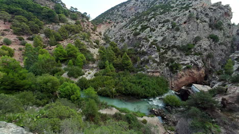 panning shot of a green valley with a river between mounains in spain