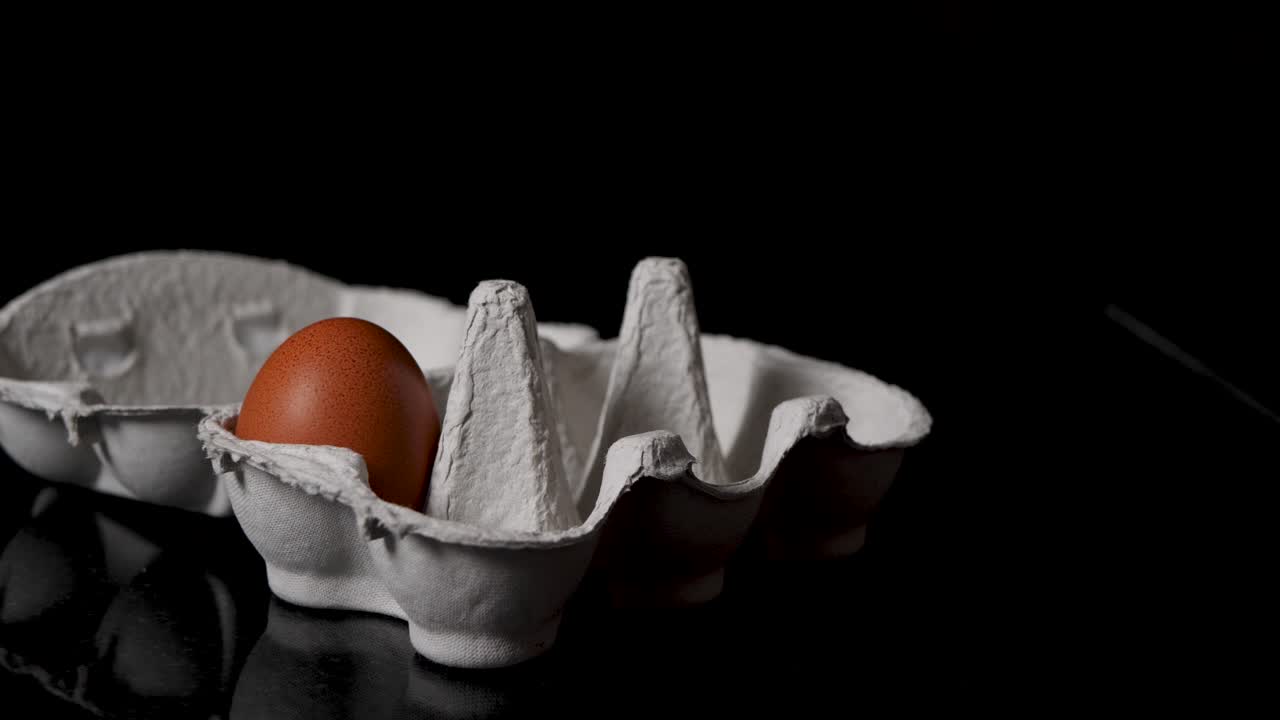 Sliding shot of someone taking out eggs out of a egg box