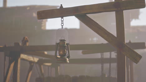 a rusty lantern hanging in ruins