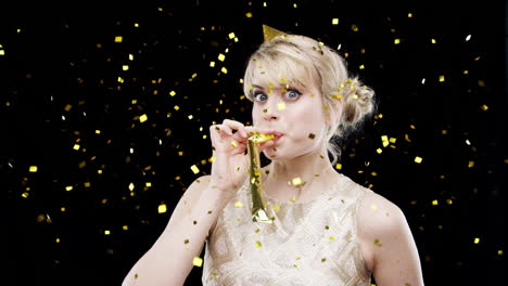 woman celebrating with confetti and noisemaker