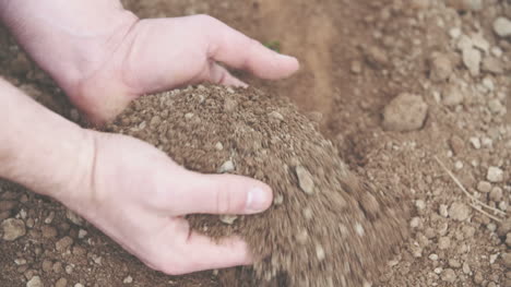 farmer with handful of soil agriculture background