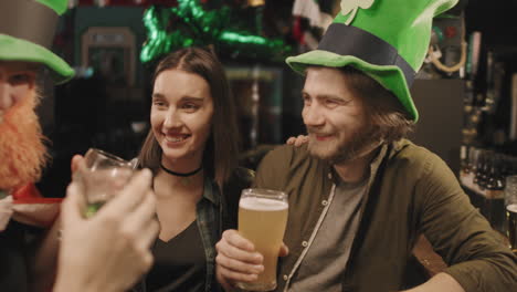 man making toast to friends in pub