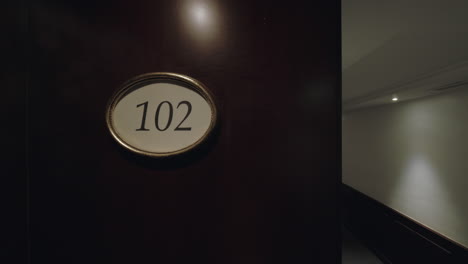 empty hotel hall and room number sign