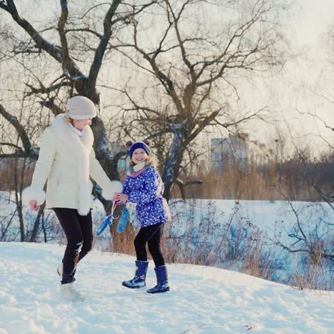 a woman with a child rejoices in winter and snow 1