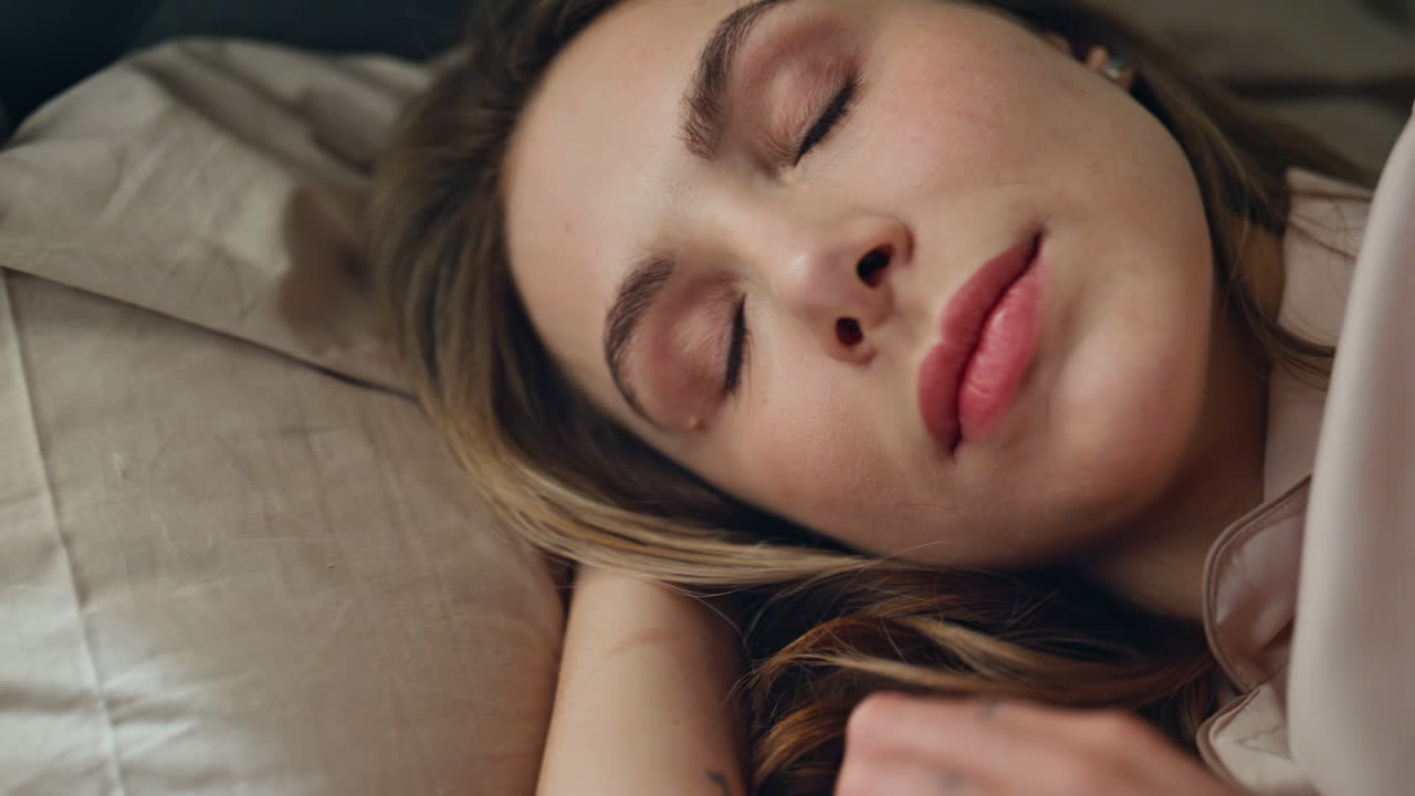 Close-up portrait of a smiling woman relaxing in bed